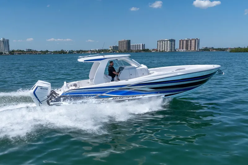 Slide: The Image of 2026 Deep Impact 369 Sport boat cruising on water at high speed. - 6