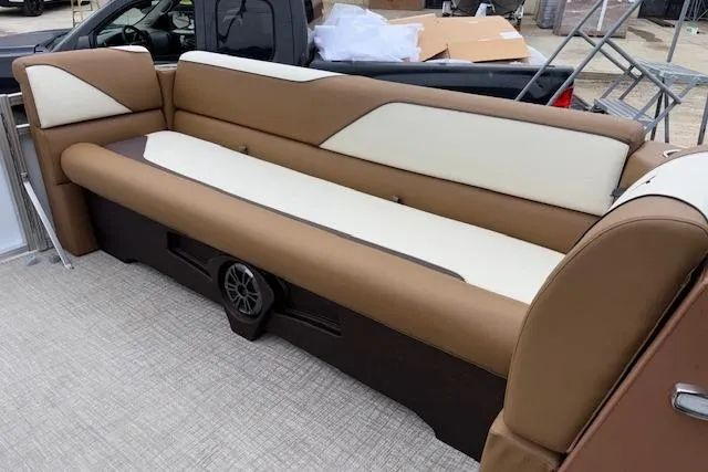 Slide: The Image of 2026 Tahoe Pontoon SP 2180 CRB boat seating, brown and cream upholstery, outdoor setting. - 13