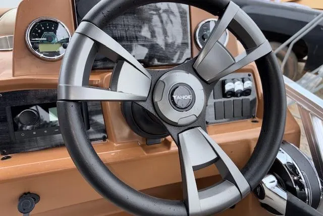 Slide: The Image of Steering wheel of 2026 Tahoe Pontoon SP 2180 CRB boat with dashboard controls. - 19