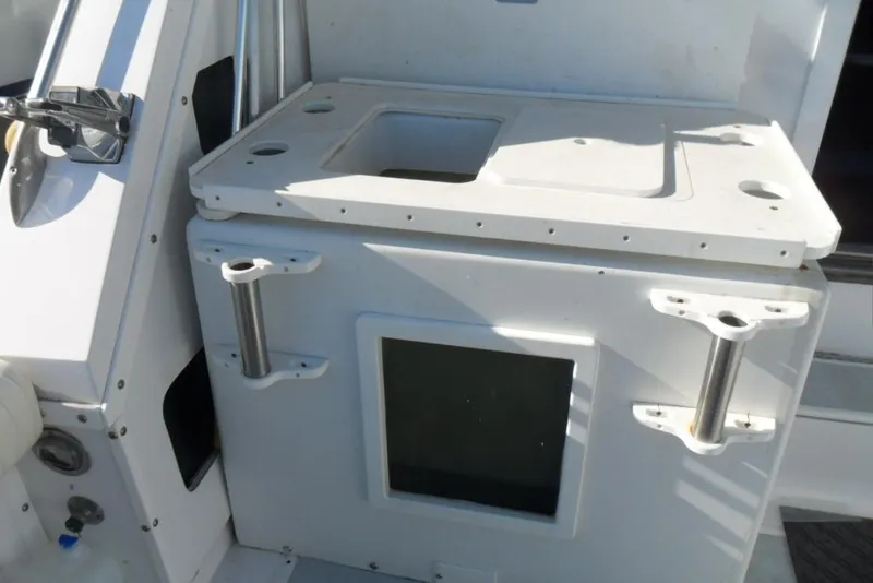 Slide: The Image of 1979 Bertram 46.6 Sport Fisher boat interior with fishing rod holders and storage compartment. - 10