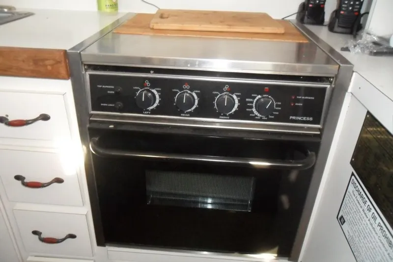 Slide: The Image of 1979 Bertram 46.6 Sport Fisher kitchen with Princess stove and oven. - 25