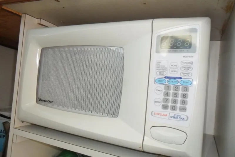 Slide: The Image of Magic Chef microwave with digital display and control panel in a kitchen setting. - 26