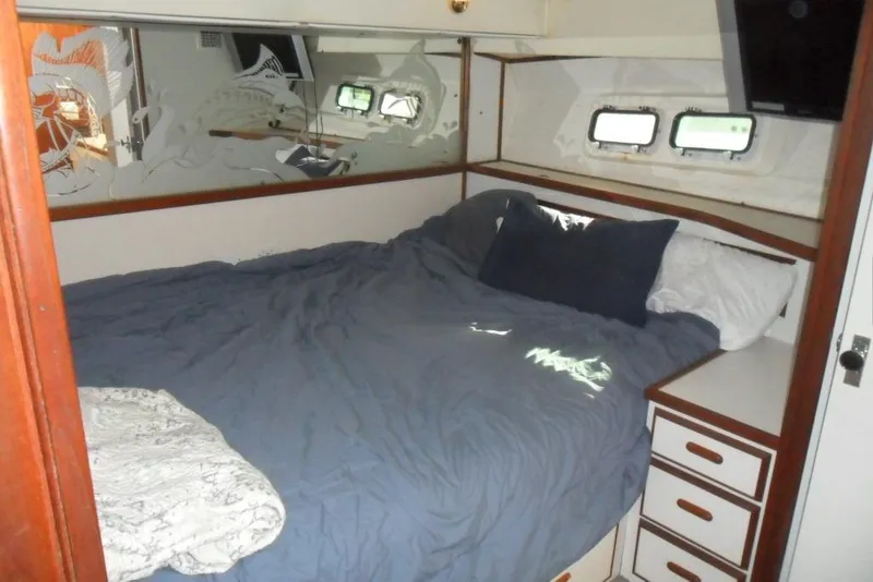 Slide: The Image of Interior cabin of 1979 Bertram 46.6 Sport Fisher with bed and porthole windows. - 29