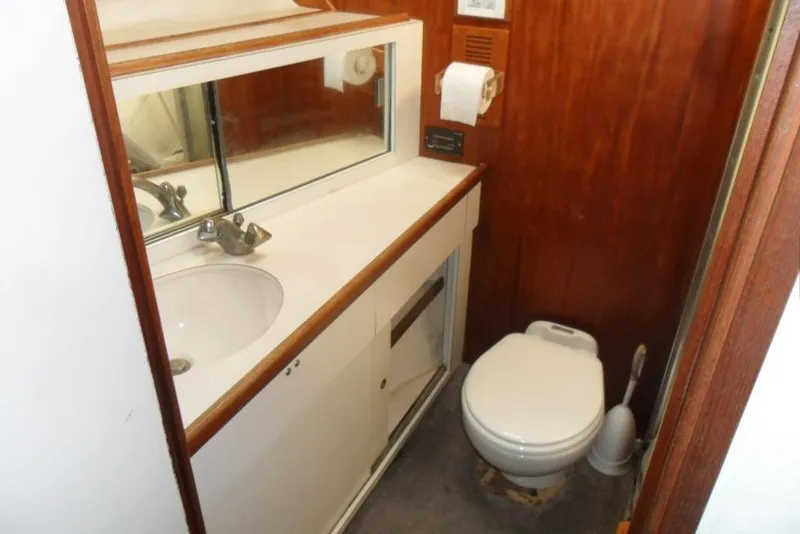 Slide: The Image of 1979 Bertram 46.6 Sport Fisher bathroom with sink, mirror, and toilet. - 32