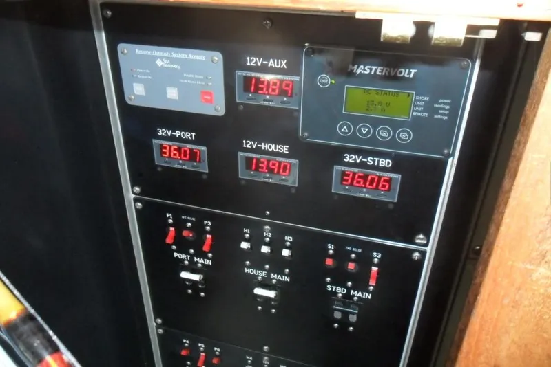 Slide: The Image of Electrical control panel on a 1979 Bertram 46.6 Sport Fisher boat, displaying voltage readings. - 33