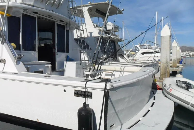 Slide: The Image of 1979 Bertram 46.6 Sport Fisher docked at marina with fishing rods. - 5