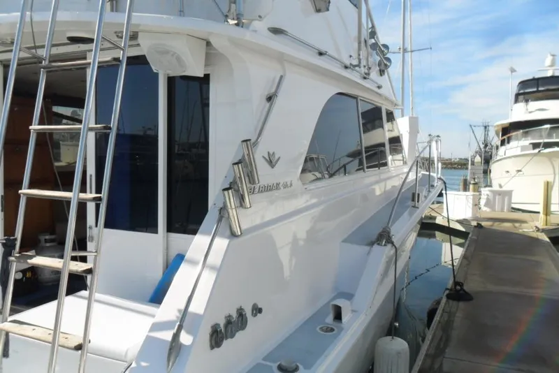 Slide: The Image of 1979 Bertram 46.6 Sport Fisher yacht docked at marina, side view. - 6