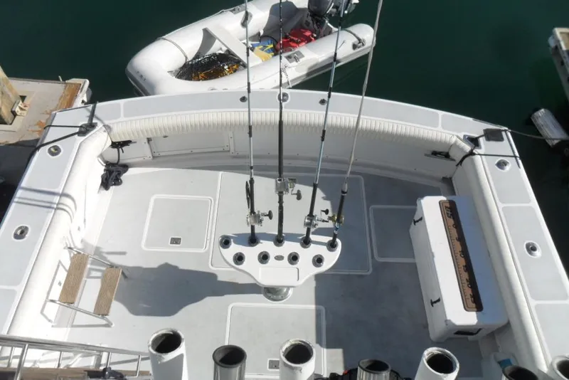 Slide: The Image of 1979 Bertram 46.6 Sport Fisher boat deck with fishing rods and equipment. - 8