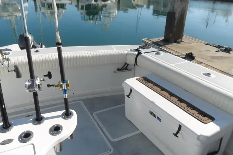 Slide: The Image of 1979 Bertram 46.6 Sport Fisher boat deck with fishing rods and cooler. - 9