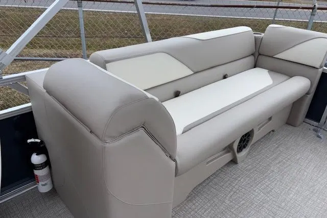 Slide: The Image of 2026 Tahoe Pontoon SPORT 2385 QUAD LOUNGE interior with beige seating and speaker. - 10