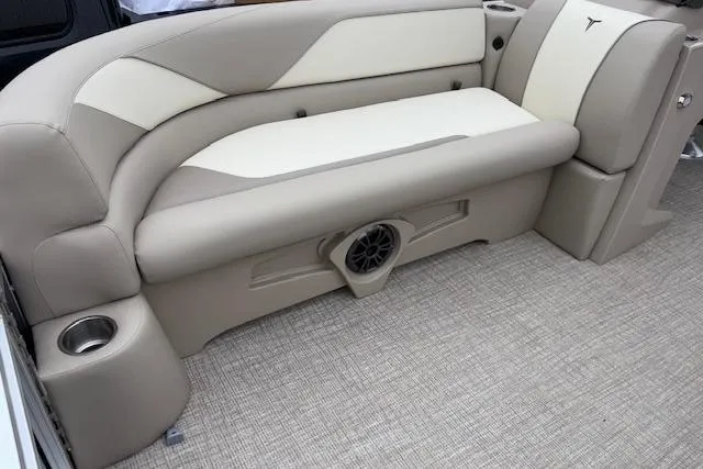 Slide: The Image of 2026 Tahoe Pontoon SPORT 2385 QUAD LOUNGE interior with beige seating and integrated speaker. - 7