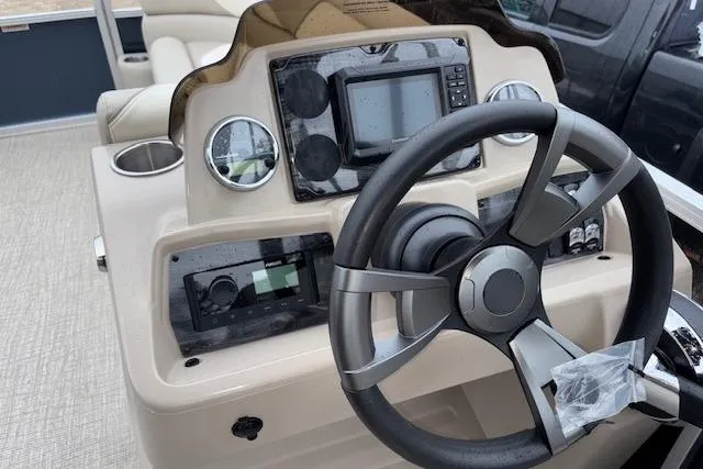 Slide: The Image of 2026 Tahoe Pontoon SPORT 2385 QUAD LOUNGE dashboard with steering wheel and controls. - 8