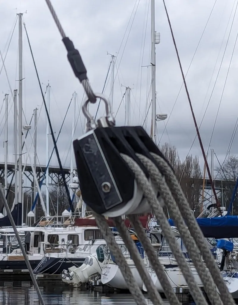 Slide: The Image of Close-up of sailboat rigging with pulleys in harbor. - 12