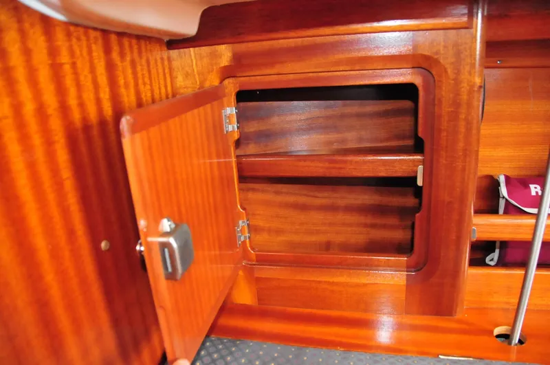 Slide: The Image of Open wooden cabinet inside a 2001 Bavaria 34 yacht. - 27