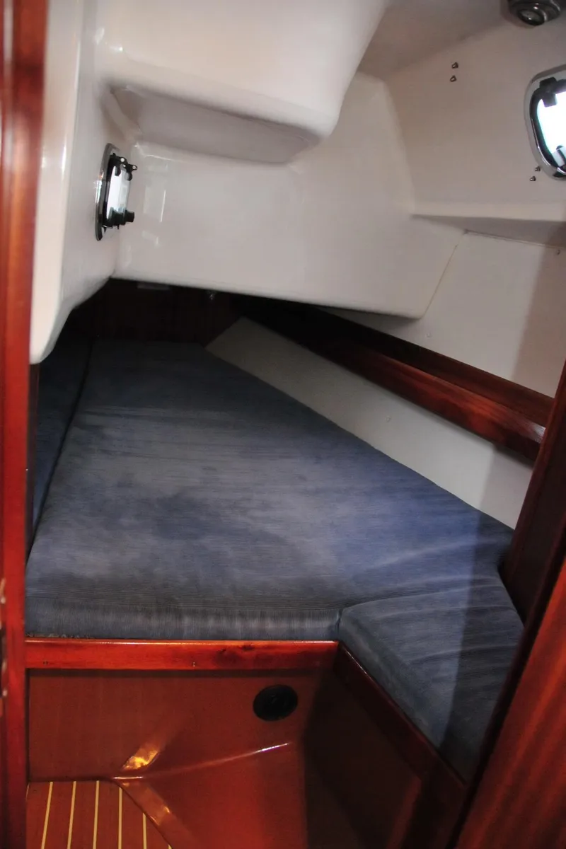 Slide: The Image of Cabin of a 2001 Bavaria 34 yacht with blue upholstery. - 30