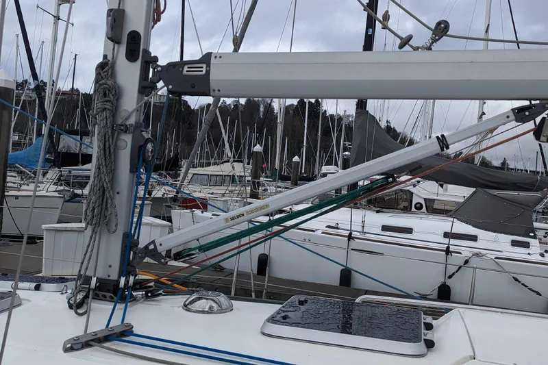 Slide: The Image of 2001 Bavaria 34 sailboat docked in marina, surrounded by other boats. - 7