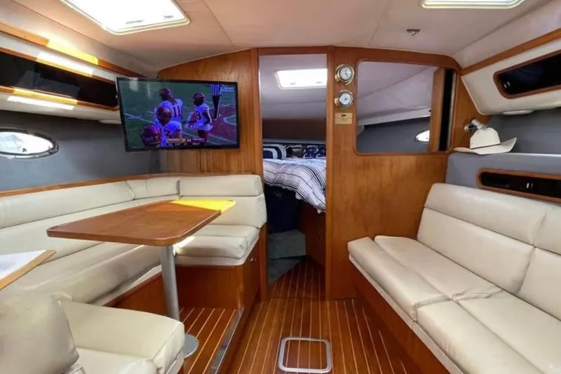 Slide: The Image of Interior of a 1990 Tiara Open yacht with cozy seating and a mounted TV. - 1