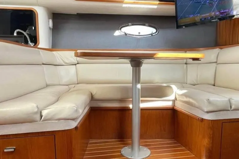 Slide: The Image of Luxurious interior of a 1990 Tiara Open yacht with leather seating and a mounted TV. - 2