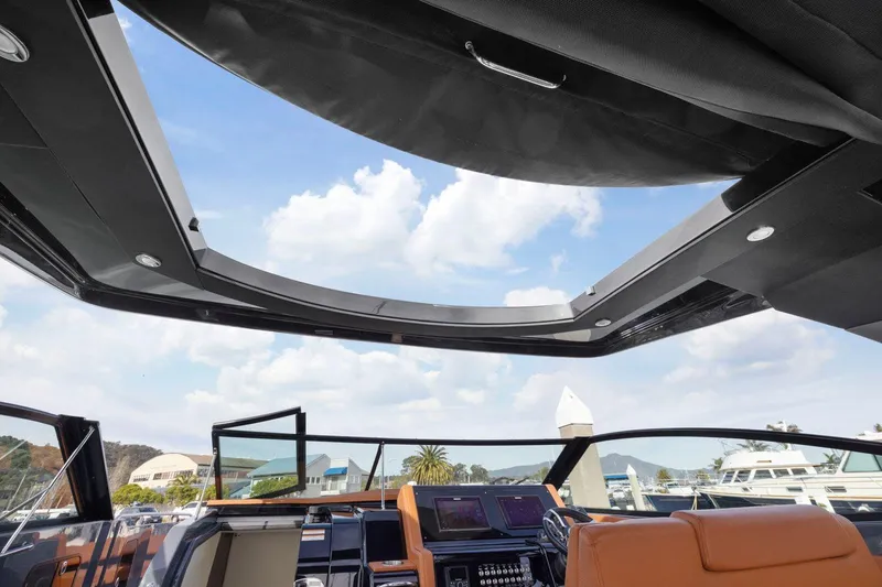 Slide: The Image of 2022 Cruisers Yachts 38 GLS South Beach IO with open sunroof and luxurious interior. - 26