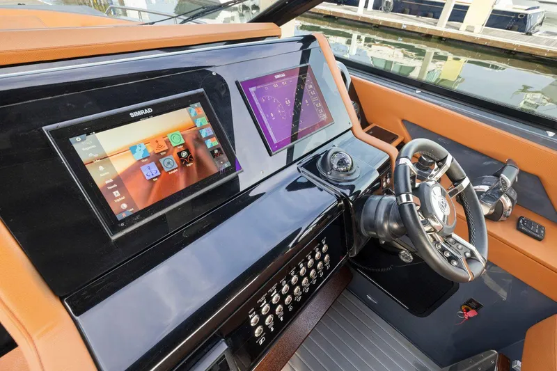 Slide: The Image of 2022 Cruisers Yachts 38 GLS South Beach IO helm with advanced navigation displays and controls. - 22