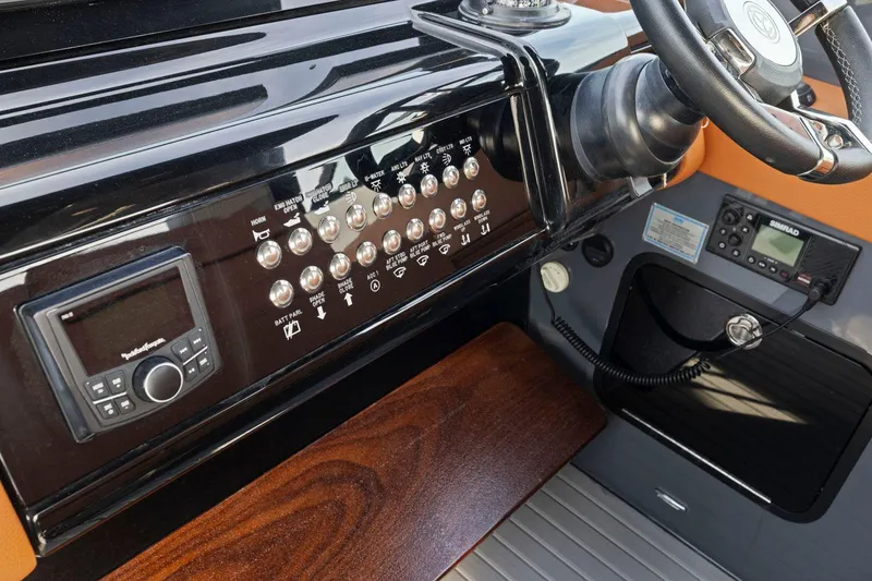 Slide: The Image of 2022 Cruisers Yachts 38 GLS South Beach IO dashboard with controls and steering wheel. - 23