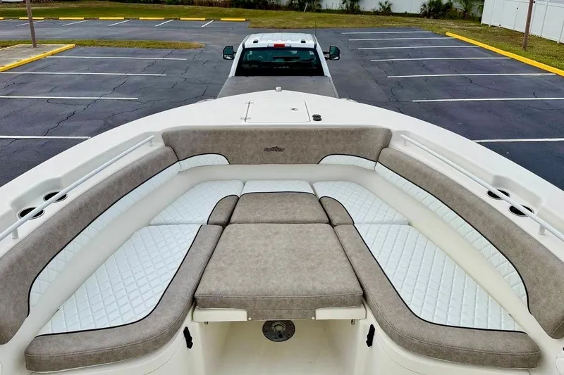 Slide: The Image of 2016 NauticStar 28 XS boat with spacious seating in a parking lot. - 10