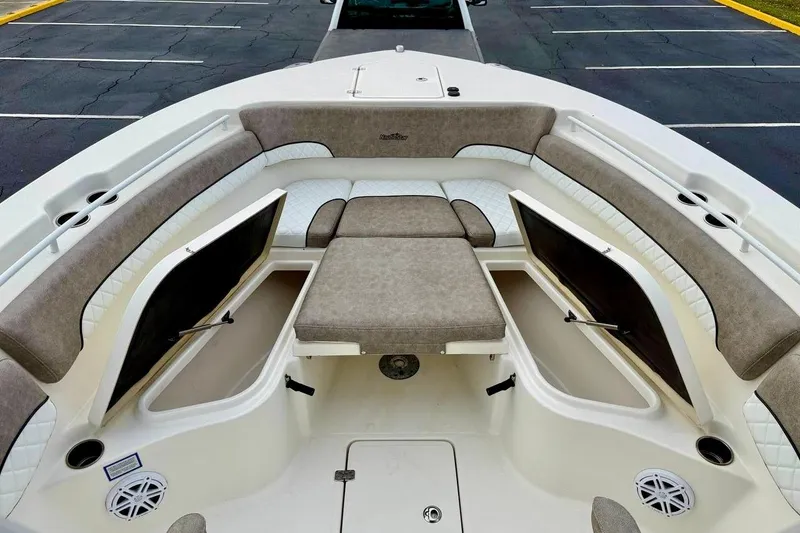 Slide: The Image of 2016 NauticStar 28 XS boat interior with cushioned seating and storage compartments. - 11