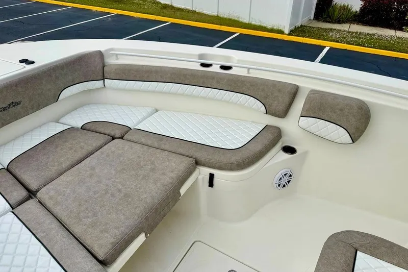 Slide: The Image of 2016 NauticStar 28 XS boat interior with cushioned seating and speaker. - 13