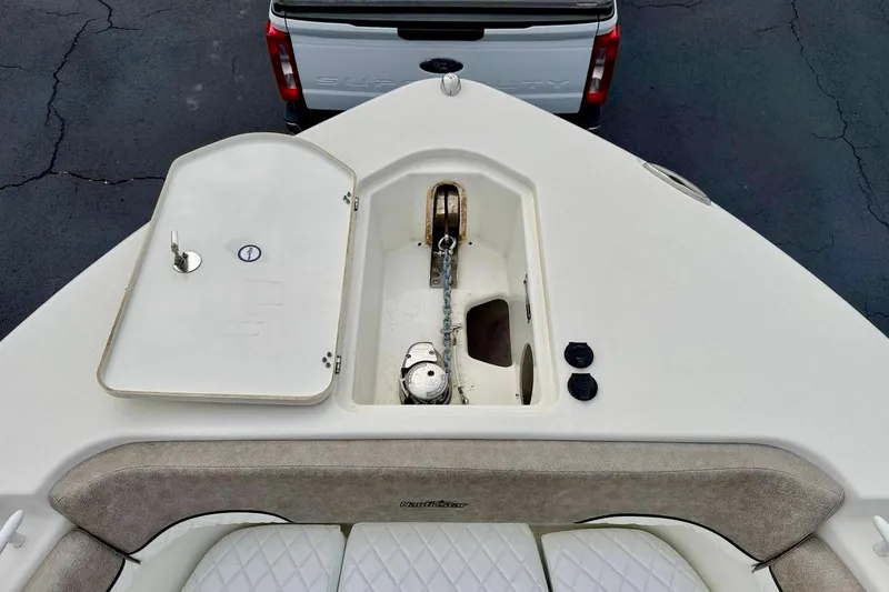 Slide: The Image of 2016 NauticStar 28 XS boat anchor compartment with open hatch, viewed from above. - 14