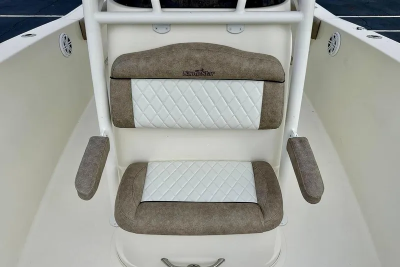 Slide: The Image of 2016 NauticStar 28 XS boat seat with white and brown cushioned design. - 18