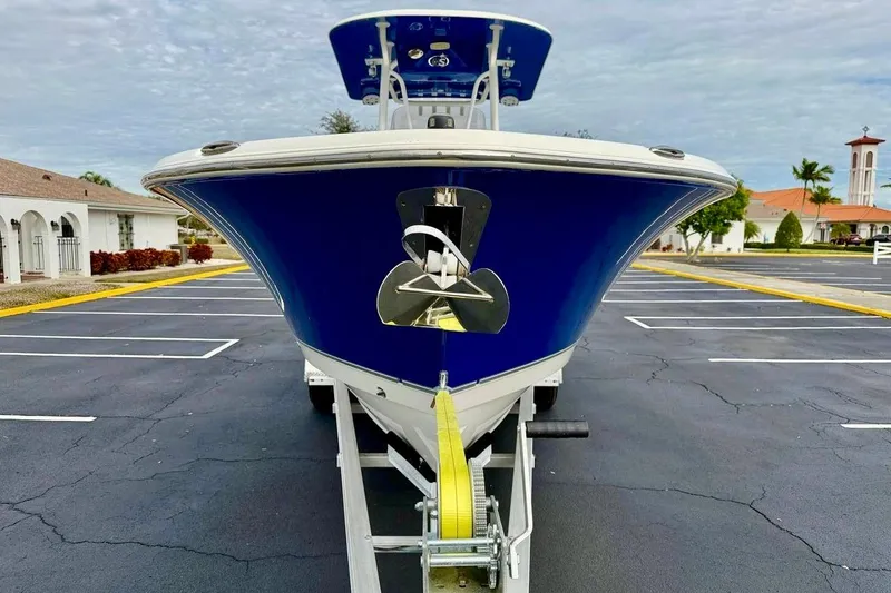 Slide: The Image of 2016 NauticStar 28 XS boat on trailer, blue hull, parked in lot. - 2