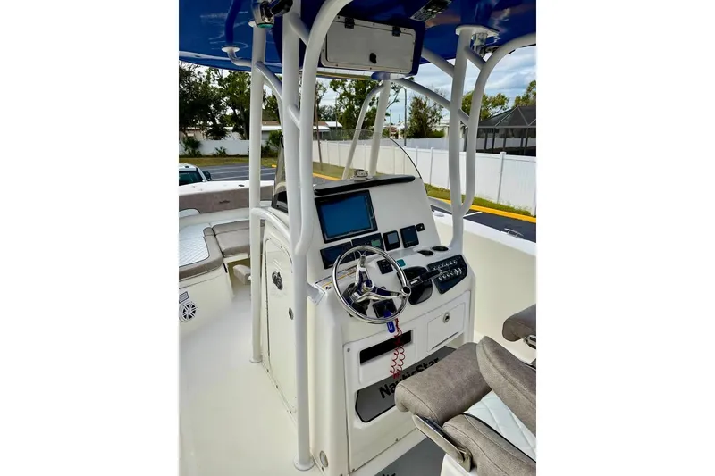 Slide: The Image of 2016 NauticStar 28 XS boat console with steering wheel and navigation equipment. - 20