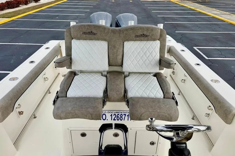 Slide: The Image of 2016 NauticStar 28 XS boat with dual cushioned seats and steering wheel. - 29