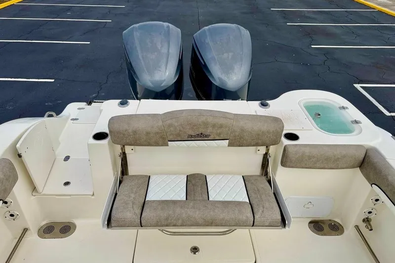Slide: The Image of 2016 NauticStar 28 XS boat interior with seating and dual engines. - 32