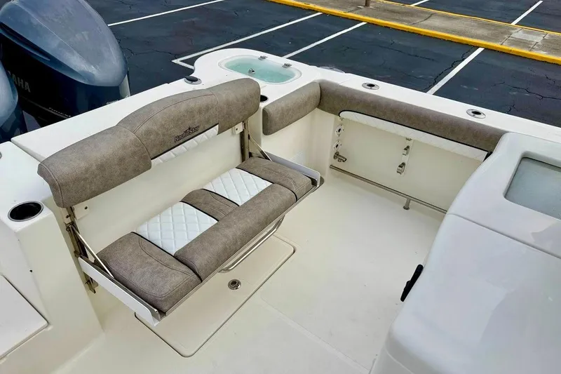 Slide: The Image of 2016 NauticStar 28 XS boat interior with cushioned seating and Yamaha engines. - 33