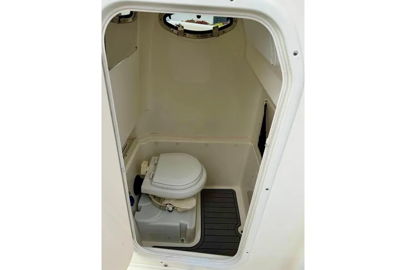 Slide: The Image of 2016 NauticStar 28 XS boat interior with compact marine toilet. - 35