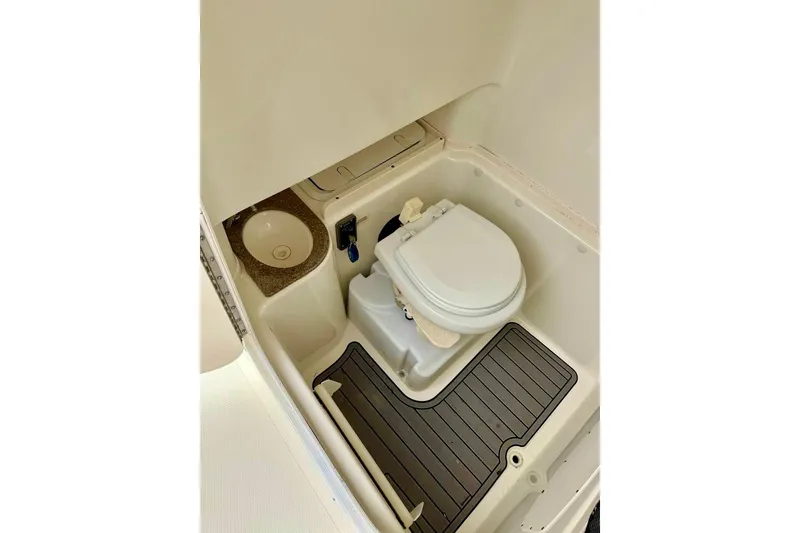 Slide: The Image of Compact bathroom in 2016 NauticStar 28 XS boat with toilet and sink. - 36