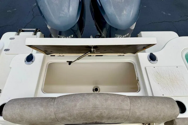 Slide: The Image of 2016 NauticStar 28 XS boat with open storage compartment and dual Yamaha engines. - 39