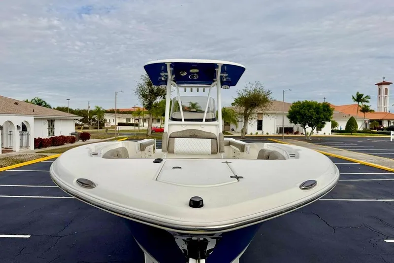 Slide: The Image of 2016 NauticStar 28 XS boat parked in a residential area, showcasing its sleek design. - 8