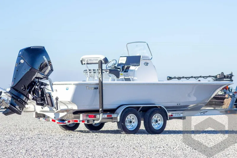 Slide: The Image of 2026 Tidewater 2110 Bay Max boat on trailer, featuring a powerful outboard motor. - 11