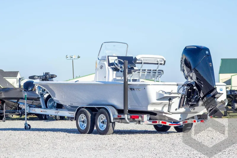 Slide: The Image of 2026 Tidewater 2110 Bay Max boat on trailer, featuring sleek design and powerful outboard motor. - 14