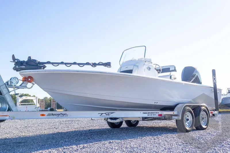 Slide: The Image of 2026 Tidewater 2110 Bay Max boat on trailer, featuring Garmin equipment, parked on gravel. - 16