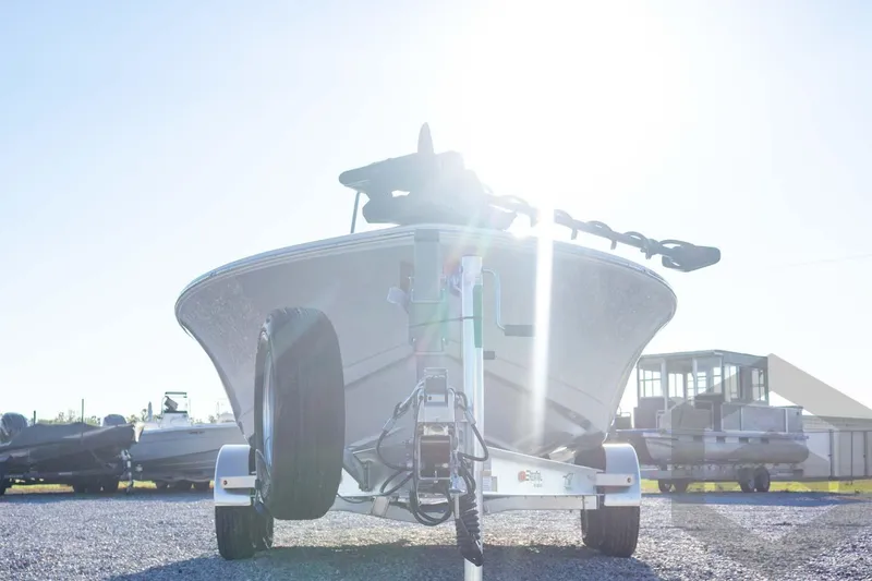Slide: The Image of 2026 Tidewater 2110 Bay Max boat on trailer, sunlit background. - 17