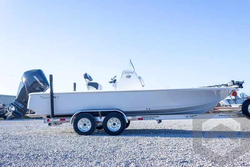 Slide: The Image of 2026 Tidewater 2110 Bay Max boat on trailer, side view, clear sky background. - 19