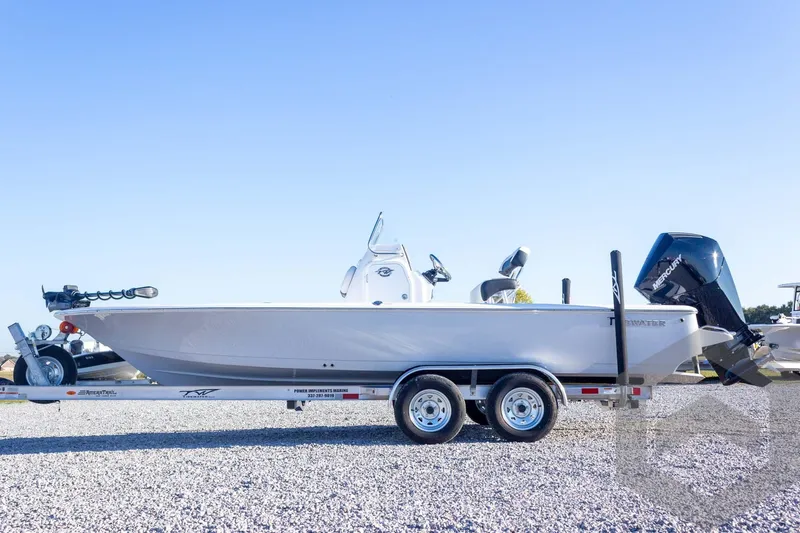 Slide: The Image of 2026 Tidewater 2110 Bay Max boat on trailer, side view, clear sky background. - 23