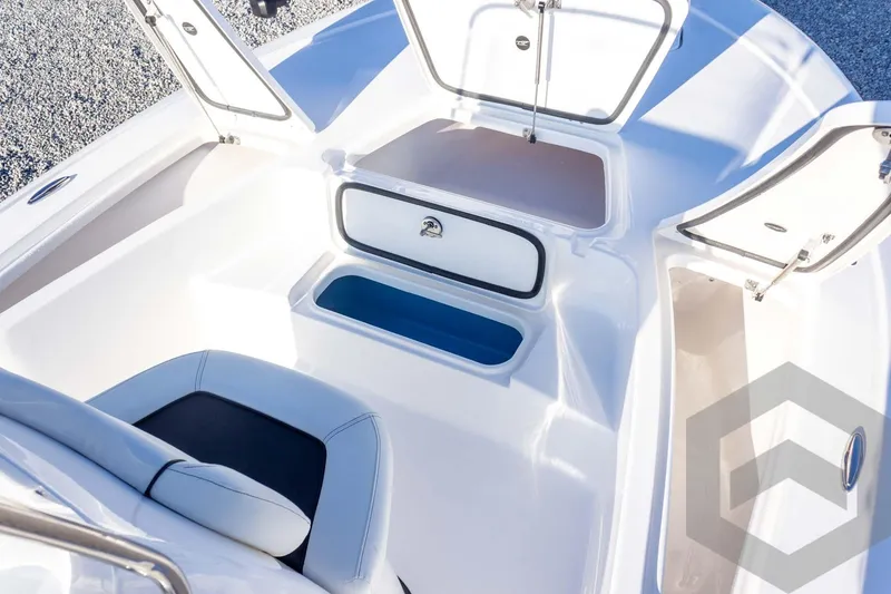 Slide: The Image of 2026 Tidewater 2110 Bay Max boat interior with open storage compartments. - 25