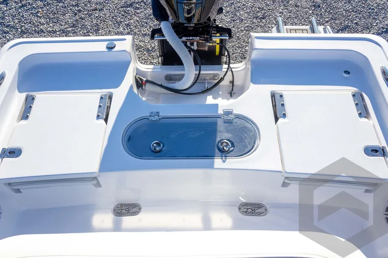 Slide: The Image of 2026 Tidewater 2110 Bay Max boat deck with storage compartments and motor. - 39