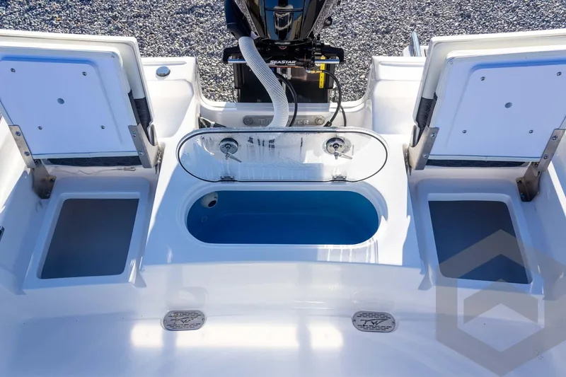 Slide: The Image of 2026 Tidewater 2110 Bay Max boat with open storage compartments and livewell. - 41