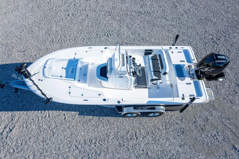 Slide: The Image of 2026 Tidewater 2110 Bay Max boat on trailer, aerial view, parked on gravel surface. - 48
