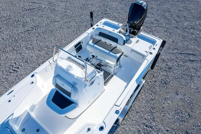 Slide: The Image of 2026 Tidewater 2110 Bay Max boat, white interior, sleek design, on gravel surface. - 55